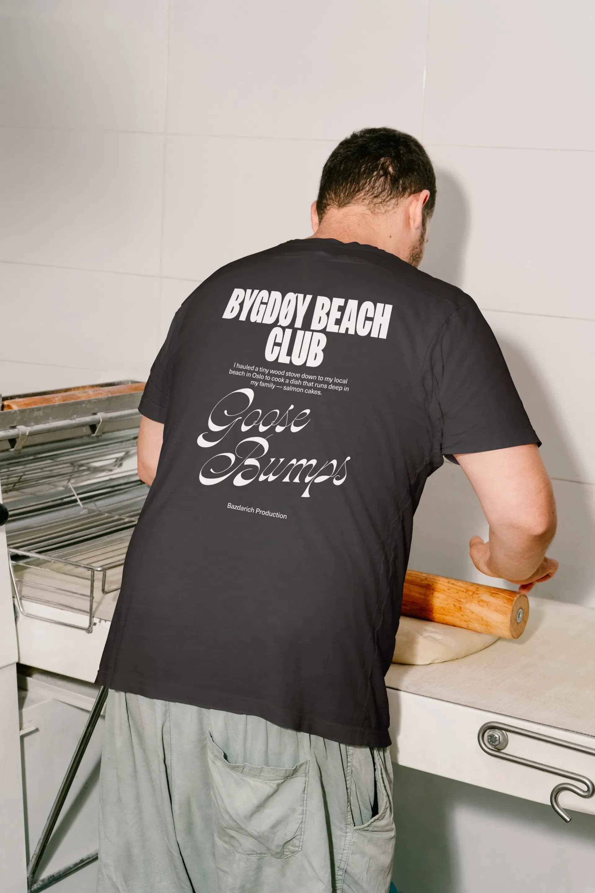 Guy in bakery wearing a T-shirt from Bazdarich Prouctions.