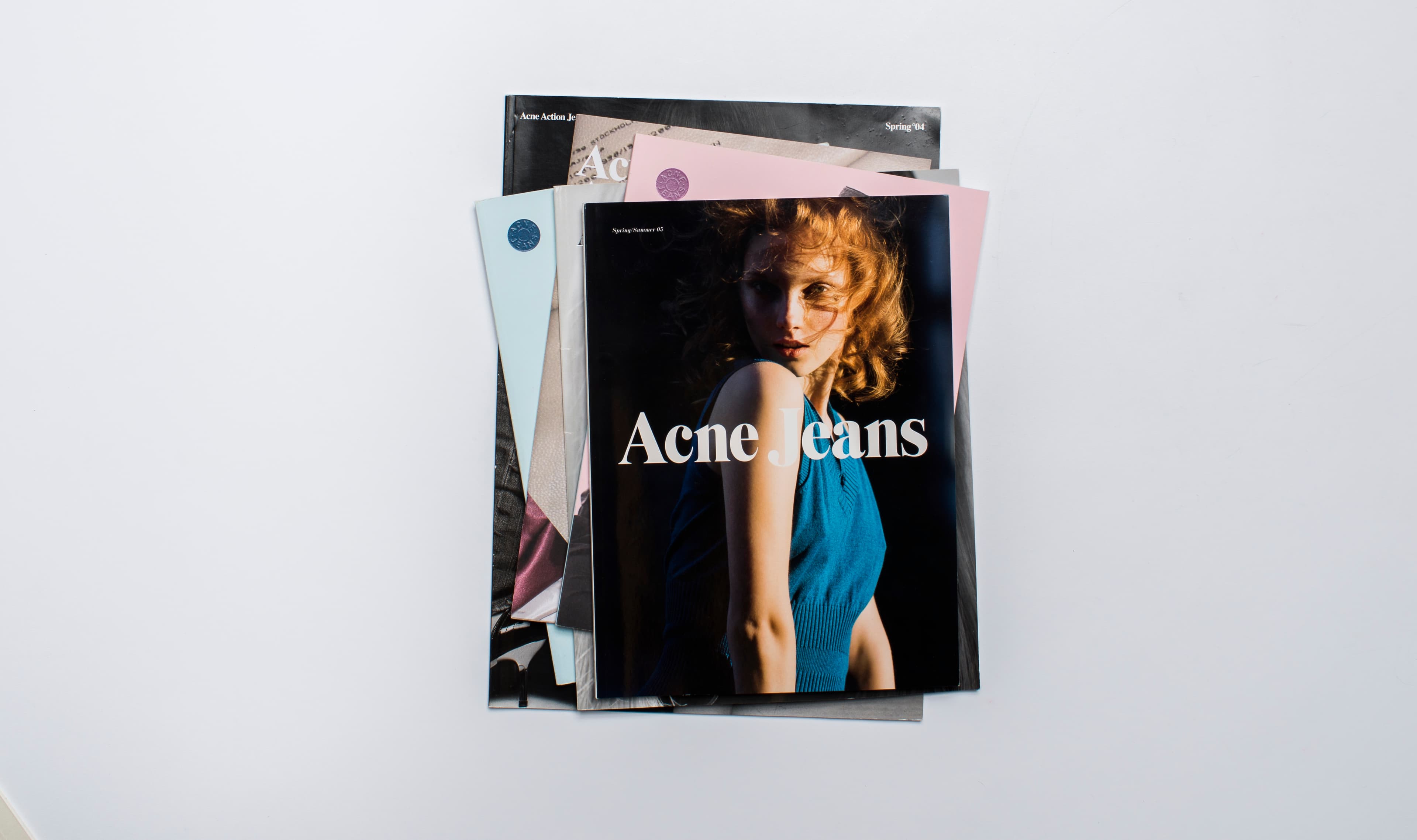 Stack of magazines for Acne on a white surface