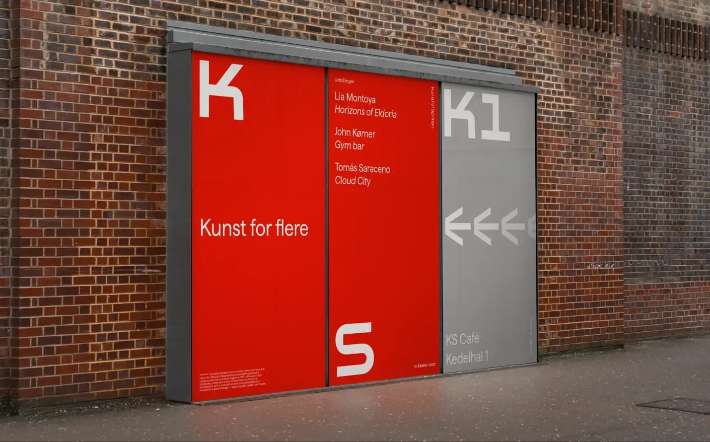 Outdoor signage on brick facade: red panels with KS logo, exhibition programme, and wayfinding to KS Café and Kedelhal 1.