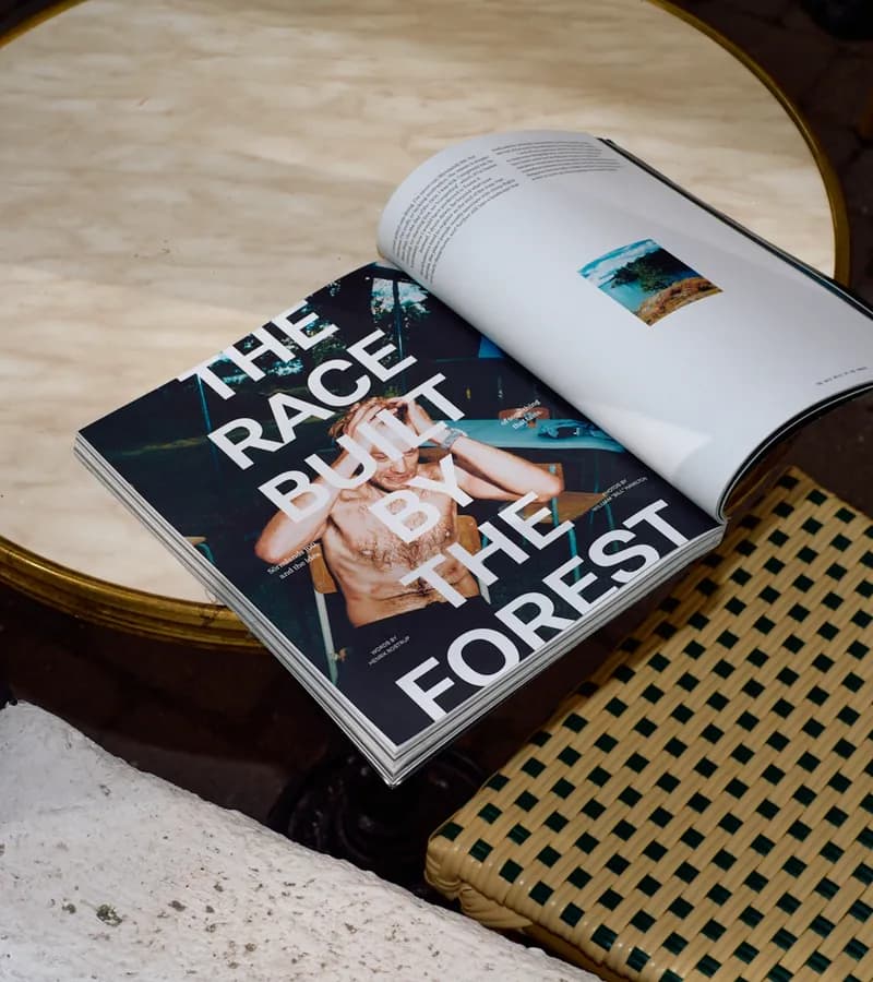 Kadens Journal cover 'The Race Built by the Forest' on Sörmlands 100: an exhausted, shirtless runner sits with crutches at an outdoor table, photos by William 'Bill' Hamilton.