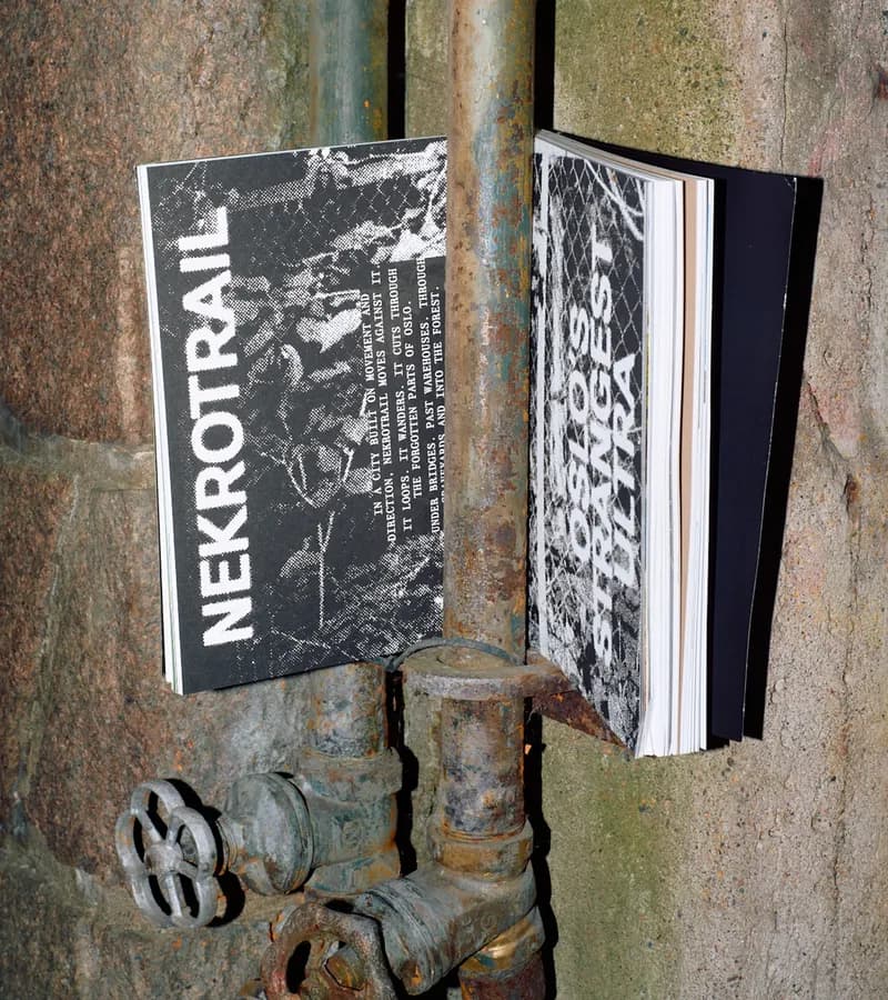 Two zine-style Kadens covers, 'Nekrotrail' and 'Oslo's Strangest Ultra', in raw black-and-white grunge typography, propped against rusty industrial pipes.