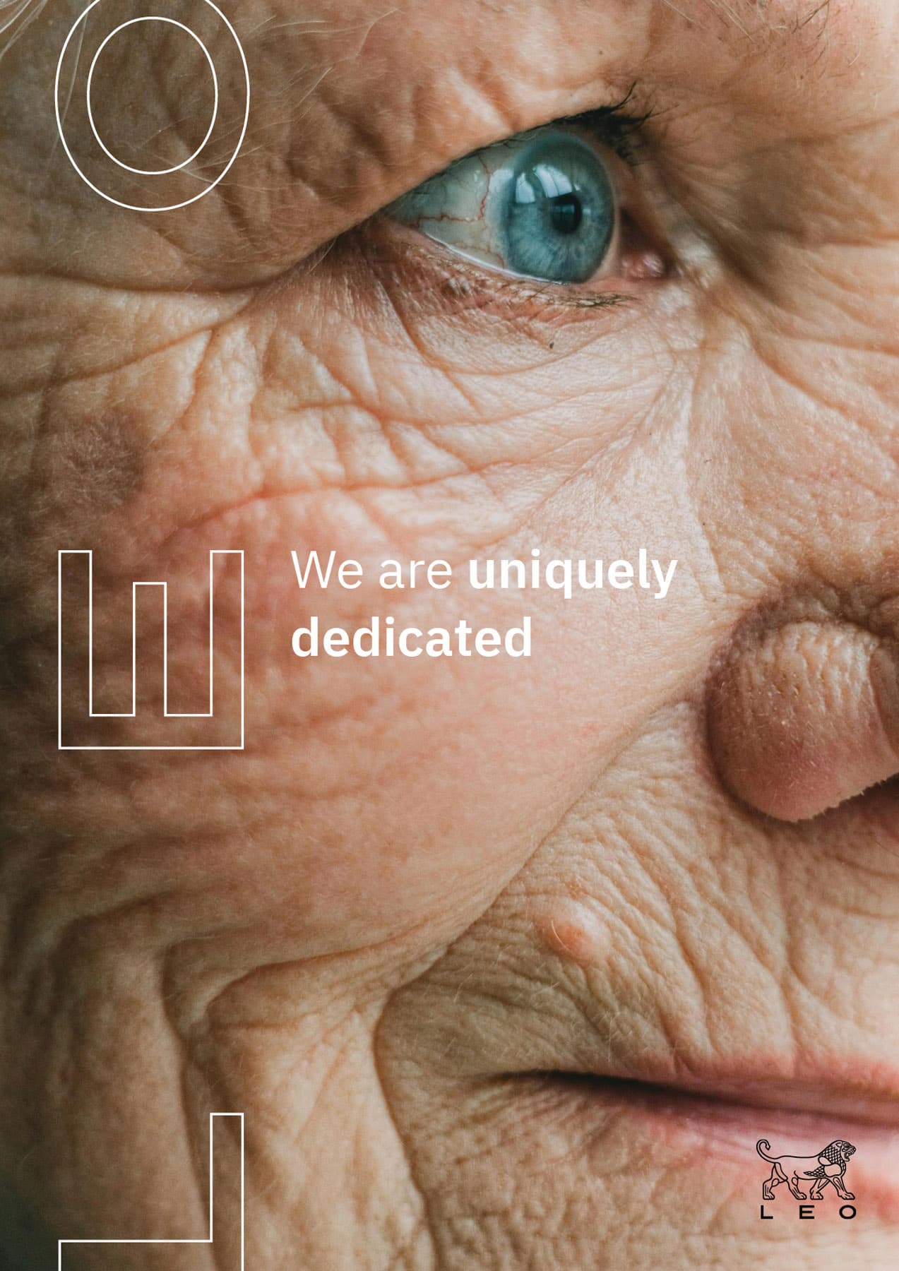LEO Pharma brand ad: Extreme close-up of elderly person's face with blue eye and wrinkled skin. Text reads 'We are uniquely dedicated' with LEO logo.
