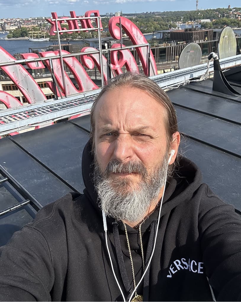 Portait of Moses Voigt taking a selfie on a roof