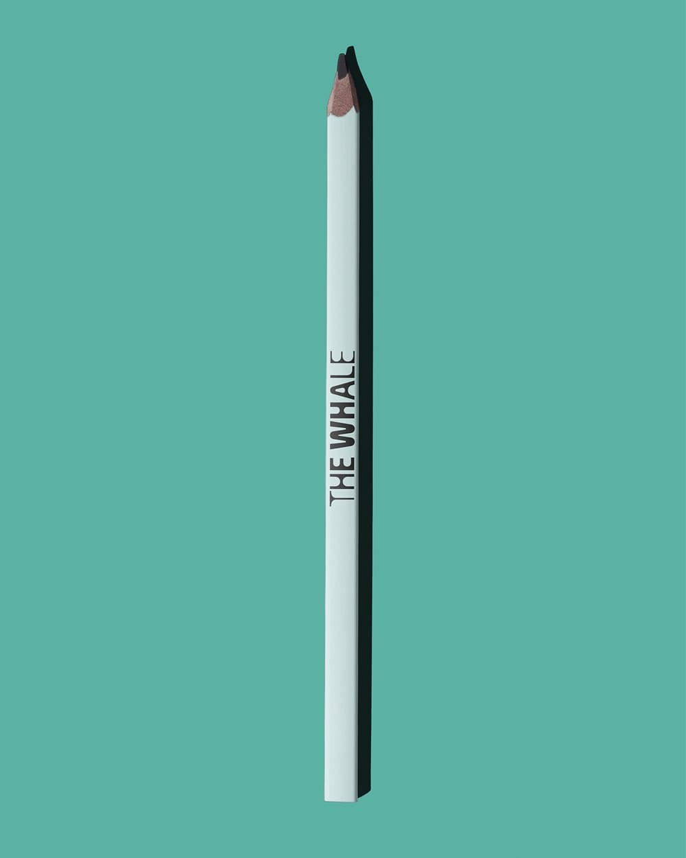 The Whale branded pencil on turquoise background