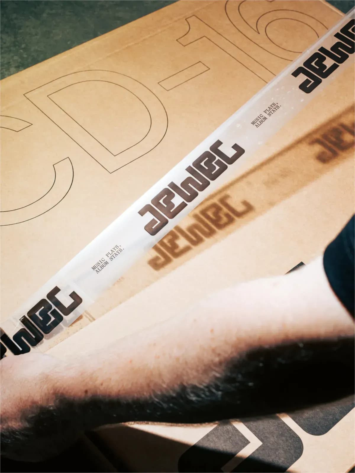 Person applying tape to a cardboard box from Jewel