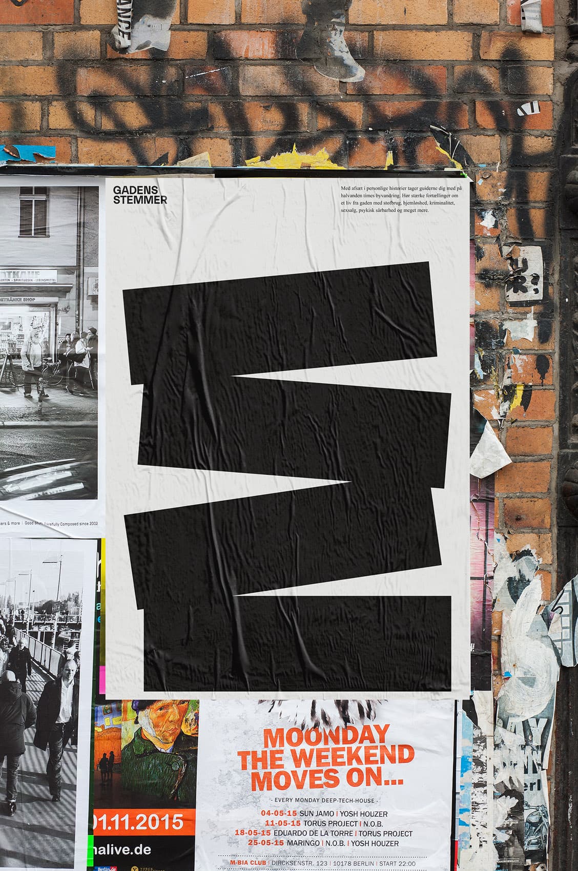 Gadens Stemmer street poster mounted on a brick wall among other posters, featuring the large black logo mark on white background
