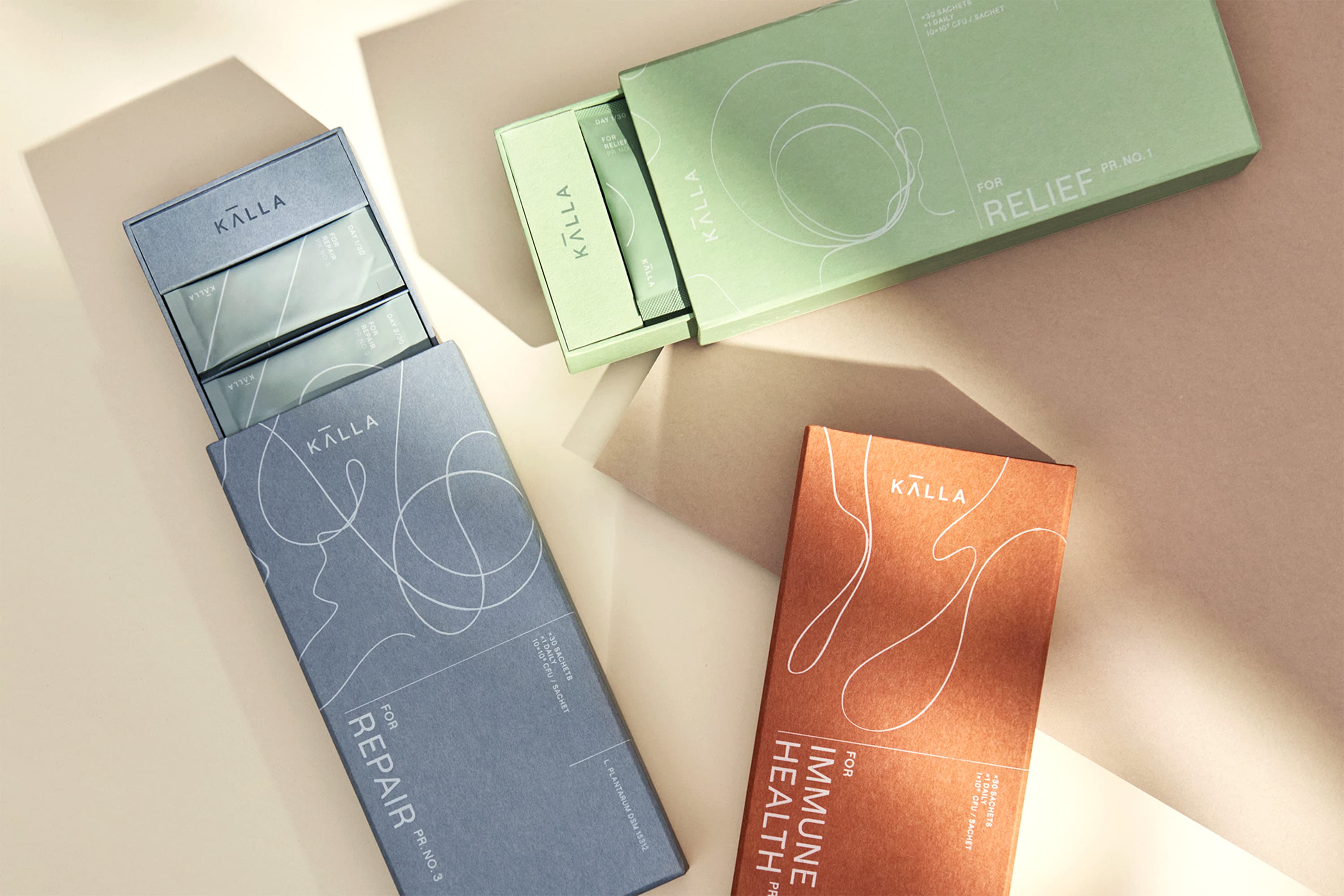 Three products from Källa placed on a table, two of them slightly opened.