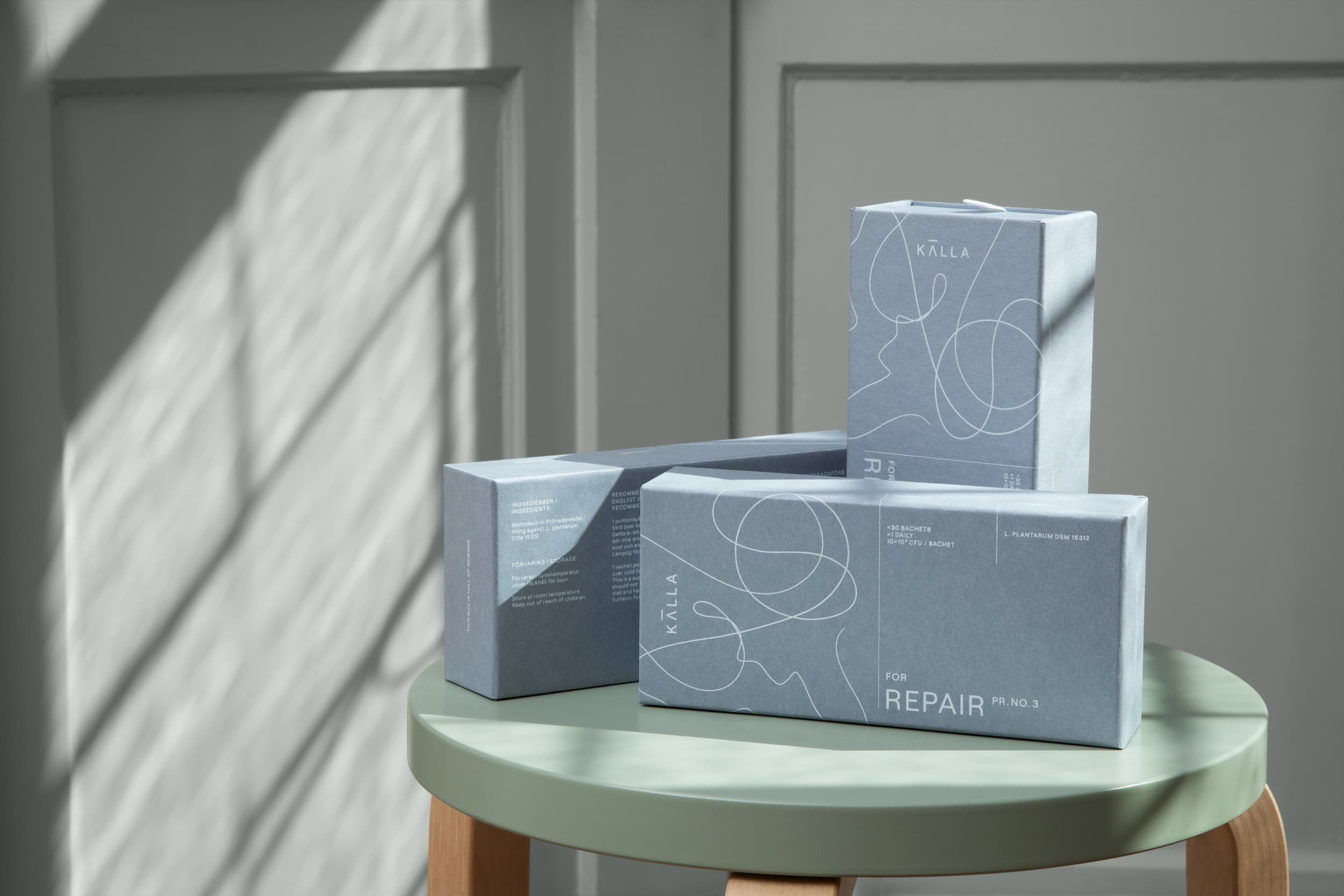 Three packs of Källa for repair placed on a stool.