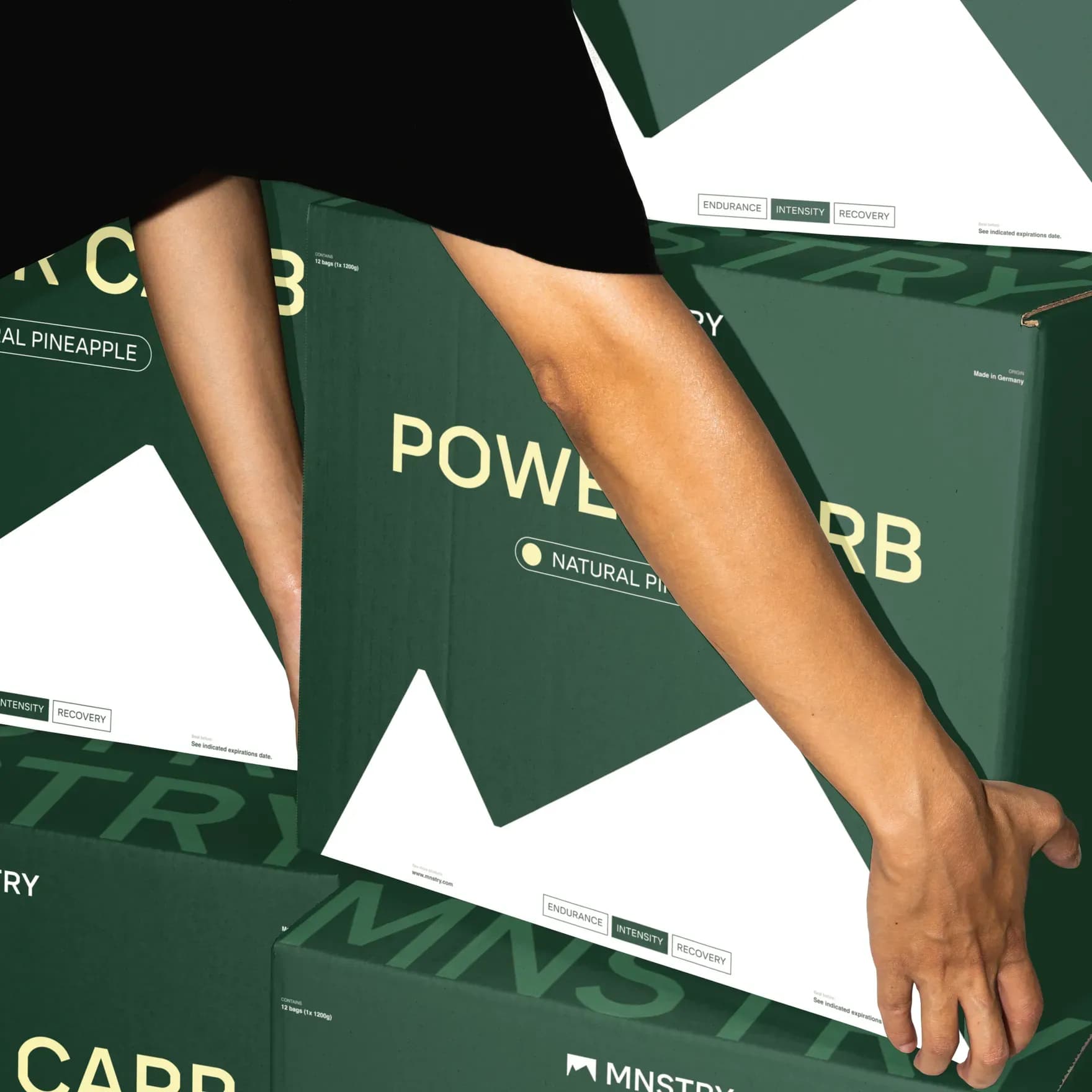 Person grabbing a box of MNSTRY products